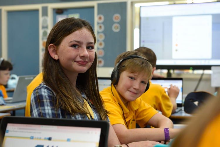Students in a classroom using laptops